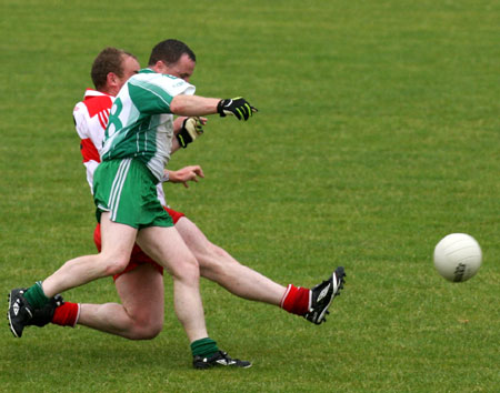 Action from the Junior B championship play-off against Glenfin.