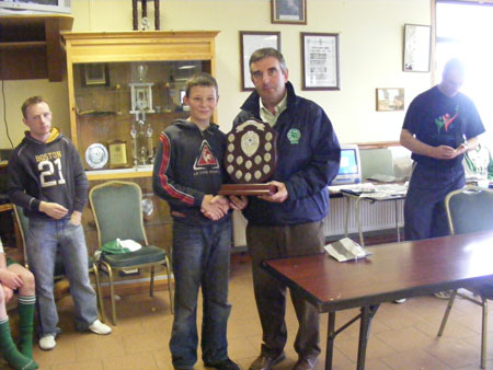 Tom Daly presenting the Aodh O Dalaigh Shield to the winning Naomh Eoin captain.