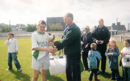 The McCumhaill's captain, Martin O' Reilly being presented with the Alan Ryan Cup by Martin 'Kerry' Ryan.