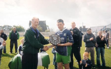 The Aodh Ruadh captain Kieran Kilgannon being presented with the Ernedale Height's Shield.