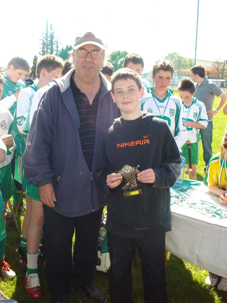 Billy Finn presenting the Pat Butler Memorial save of the tournament trophy to 
Conor Taheny from Coolera Strandhill.