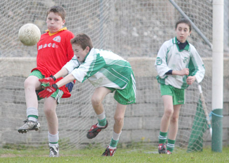 Kevin Warnock clears his lines under pressure from David McGurrin and Dominic Boyle.