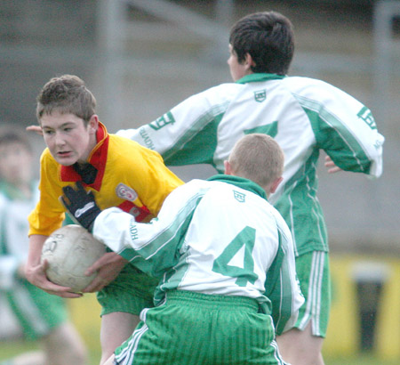 PJ Gillespie breaks tackles by Ryan Gillen and Kieran Storey.