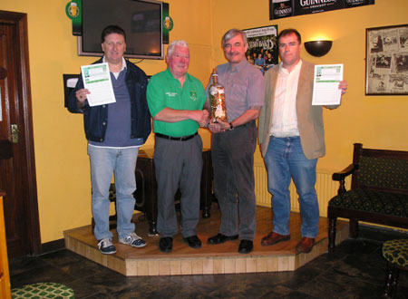  Mick McGrath of the Bridgend Bar, Ballyshannon, centre right, presents the bottle of change to the Chairman of Aodh Ruadh Bord na nÓg, Jim Kane, centre left. Also present are Paddy Kelly, Bord na nÓg committee member, far left and Eunan Doyle, Chairman of Ballyshannon Town Council and Bord na nÓg committee member.