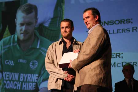 Hurling chairman, John Rooney, presents Kevin McDermott with the hurler of the year award.