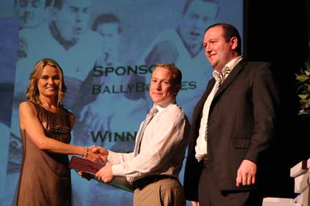 Paula Keon presents Philip O'Reilly with the Ciaran Keon senior player of the year award as senior team sponsor, John Patton watches on.