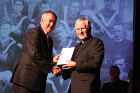Christy Cooney makes the presentation to Father Gerard Daly.