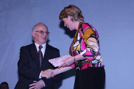 Club Secretary, John Magee, presents the Tnaiste, Mary Couaghlan, with a token of appreciation.