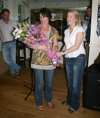 Emma Gaughan, Aodh Ruadh Hurling Secretary, presents flowers to Dennis' wife, Ethel, on behalf of the Aodh Ruadh Hurling Committee.