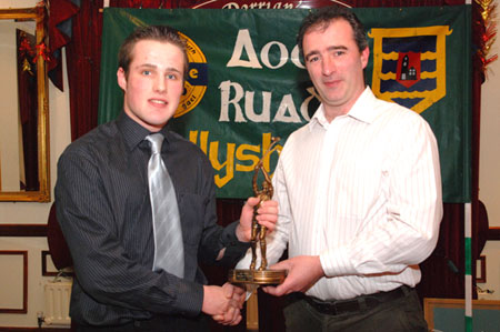 Stephen Ryan recieves the Young Hurler award from John Rooney.
