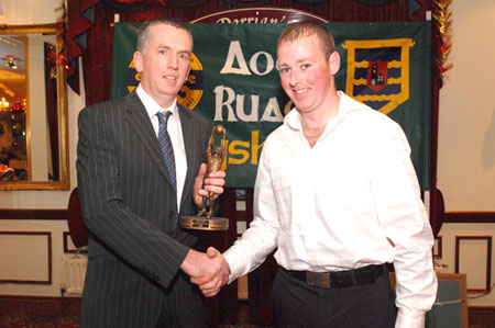 Gerard McGloin presents Brian Dorrian with the Third team player of the year award.
