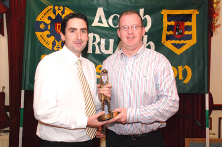 Barry Travers receives the Reserve Player of the year award from Val Murray.