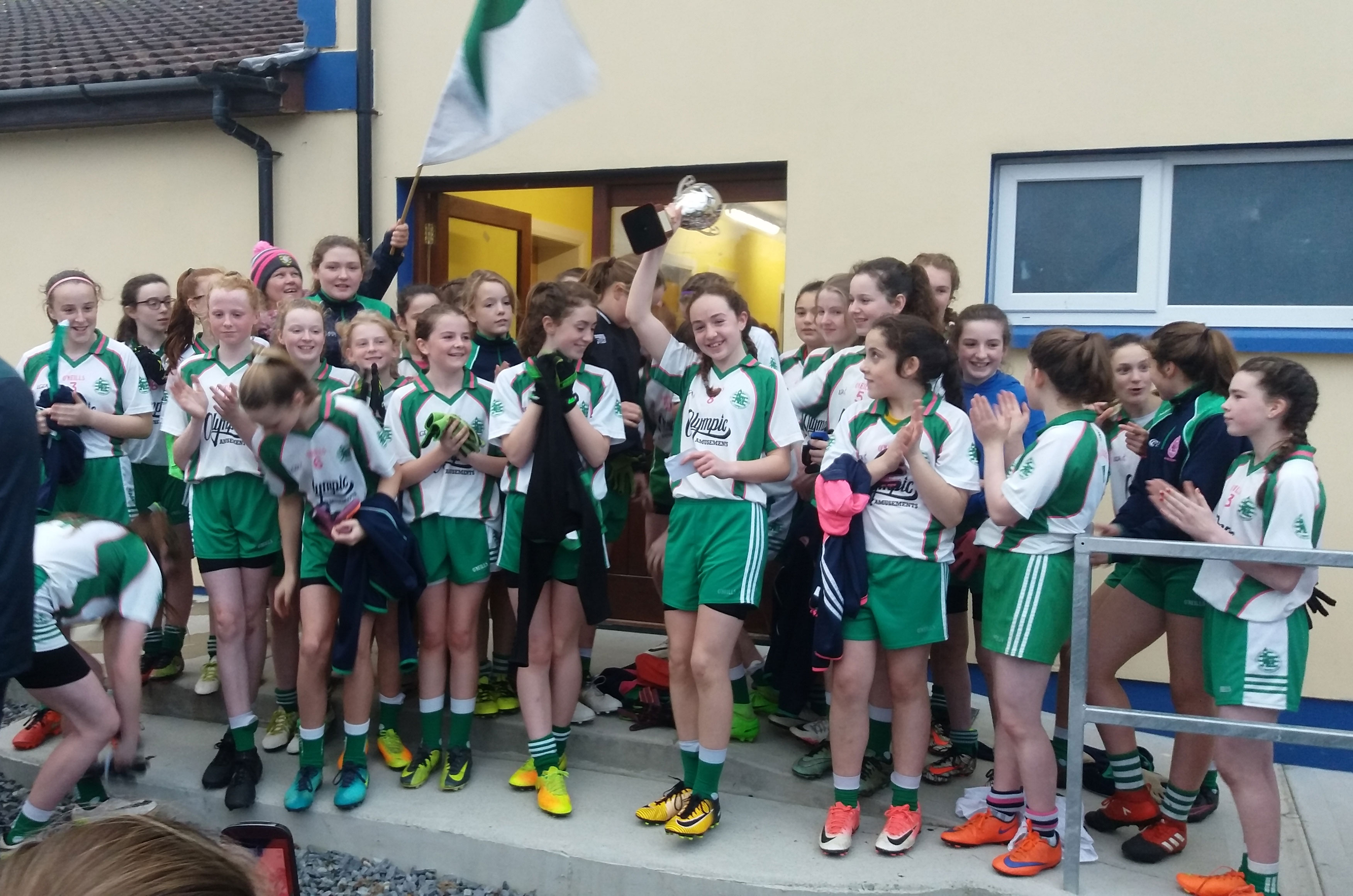 Aodh Ruadh captain Caoimhe Hughes-O'Brien raising the championship trophy.