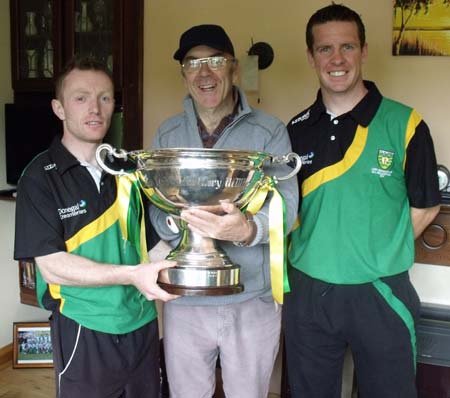 A proud Kilkenny man, Billy Finn, holds the Lory Meagher trophy.