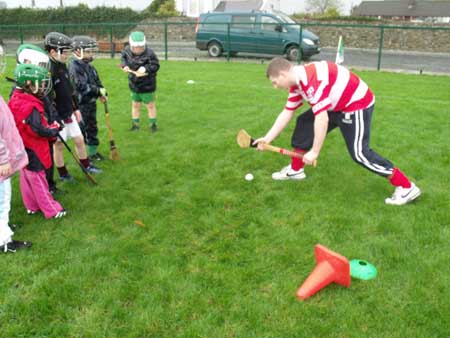 Shane Power demonstrating the roll lifts to attentive Aodh Ruadh under 8s.