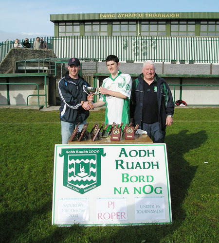 Mary Roper with the Aodh Ruadh captain, David Dolan, after the final of the PJ Roper under 16 tournament in Ballyshannon last Saturday. Brian Roper is to the right of the picture.