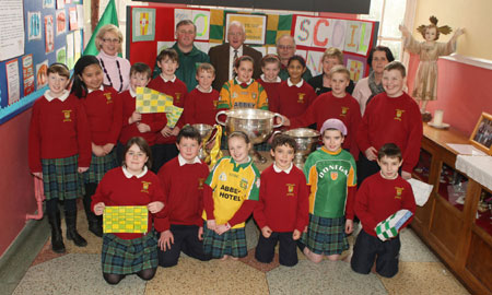 Pupils from Scoil Catriona National School, Ballyshannon pictured with the Sam Maguire, Tom Markham (All-Ireland minor football championship) and McKenna cups when they visited their school last Friday.