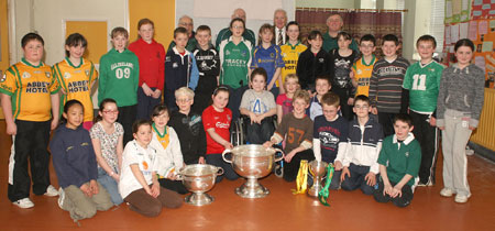 Pupils from Creevy National School, Ballyshannon pictured with the Sam Maguire, Tom Markham (All-Ireland minor football championship) and McKenna cups when they visited their school last Friday..