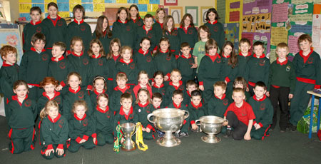 Pupils from Gael Scoil Ballyshannon pictured with the Sam Maguire, Tom Markham (All-Ireland minor football championship) and McKenna cups when they visited their school last Friday.