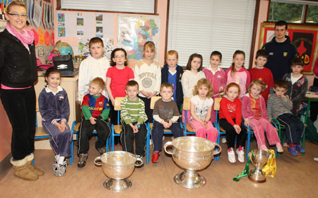 Pupils from Rockfield National School, Ballyshannon pictured with the Sam Maguire, Tom Markham (All-Ireland minor football championship) and McKenna cups when they visited their school last Friday. Also pictured is Donegal and Aodh Ruadh player former pupil Johnny Gallagher.