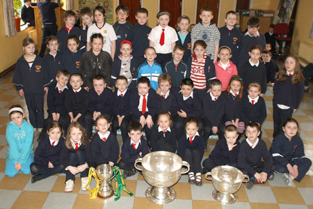 Pupils from Holy Family National School, Ballyshannon pictured with the Sam Maguire, Tom Markham (All-Ireland minor football championship) and McKenna cups when they visited their school last Friday.