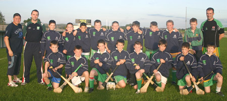 Aodh Ruadh under 12 hurlers with Peter Horan, manager, John Rooney, selector, and Packie McGrath of McGrath's Bouncy Castles, sponsors of the teams new tracksuits.