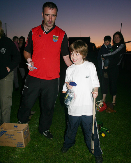 Stephen Lee, second place in the under 8 skills competition, accepting his medal from John Rooney.
