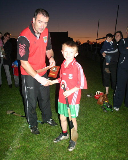 Liam O'Sullivan, winner of the under 8 skills competition, accepting his award from John Rooney.