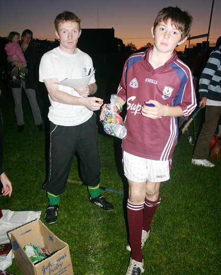 Peter Horan presenting Oisin Rooney with his medal for coming second in the under 10 skills competition.