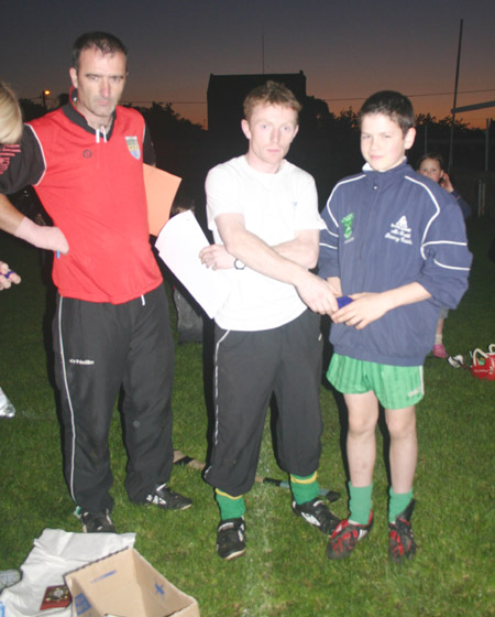 Peter Horan presents Colm Kelly with his medal for coming third in the under 12 skills competition.