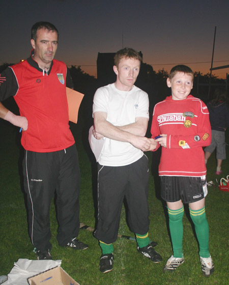 Peter Horan presents Jamie Brennan with his medal for coming second in the under 12 skills competition.