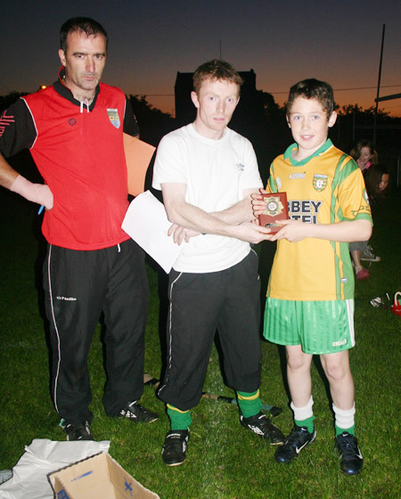Peter Horan presenting Eddie Lynch with his award for winning the under 12 skills competition.