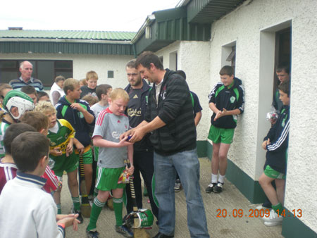 Michael Ayres, under 10 joint manager, presenting Barry Kelly, first in the under 10 section with his medal.