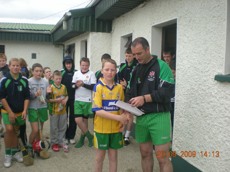 John Rooney, under 12 manager, presenting Deva Ayres, sixth in the under 12 section with his medal.