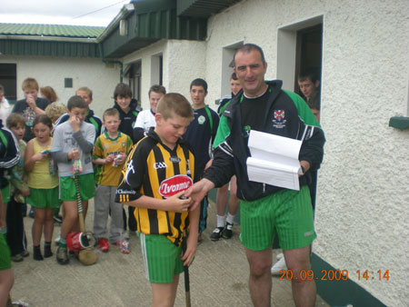 John Rooney, under 12 manager, presenting Brian Ward, fifth in the under 12 section with his medal.