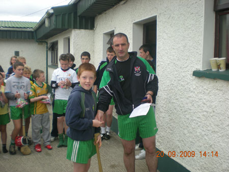 John Rooney, under 12 manager, presenting Shane McGrath, third in the under 12 section with his medal.
