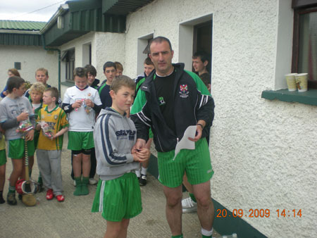 John Rooney, under 12 manager, presenting Ciaran Kelly, second in the under 12 section with his medal.