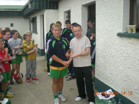 Peter Horan, under 14 manager, presenting Shane Mulhern, fifth in the under 14 section with his medal.