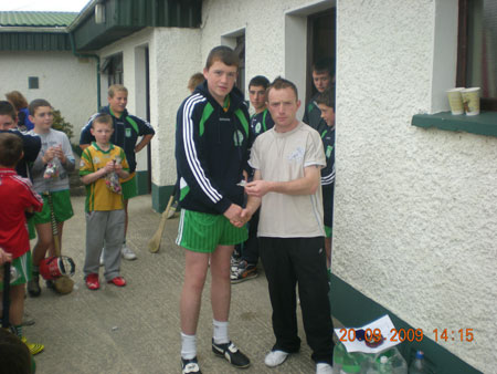 Peter Horan, under 14 manager, presenting Eamon McGrath, fourth in the under 14 section with his medal.