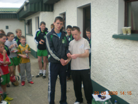 Peter Horan, under 14 manager, presenting James Kelly, third in the under 14 section with his medal.