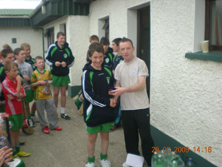 Peter Horan, under 14 manager, presenting Eddie Lynch, first in the under 14 section with his medal.