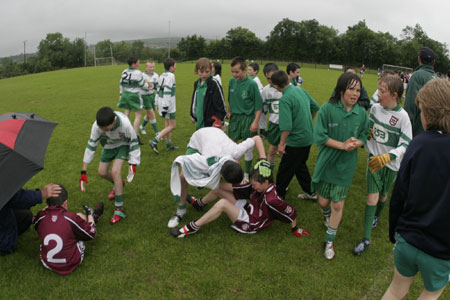Aodh Ruadh players console their Termon counterparts after the final whistle.
