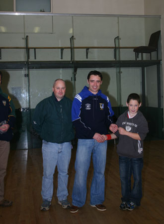 Alan Kerins presents Eddie Lynch with his under 12 hurling medal, accompanied by mentor, Eddie Lynch senior.