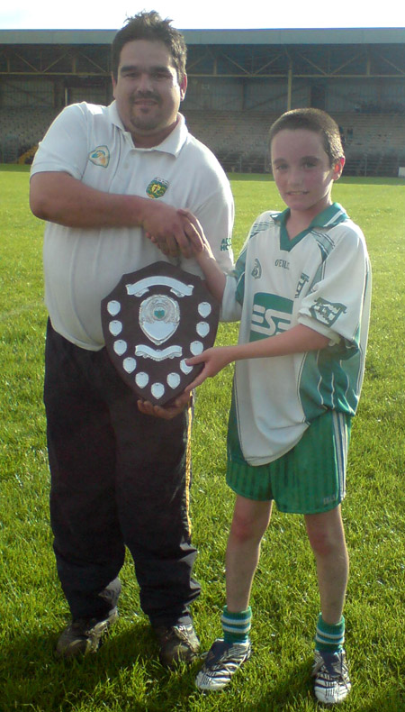 Rory McGonigle, Donegal Hurling Chairman, presenting the County Shield to the victorious Aodh Ruadh Captain, Donal O'Keefe.